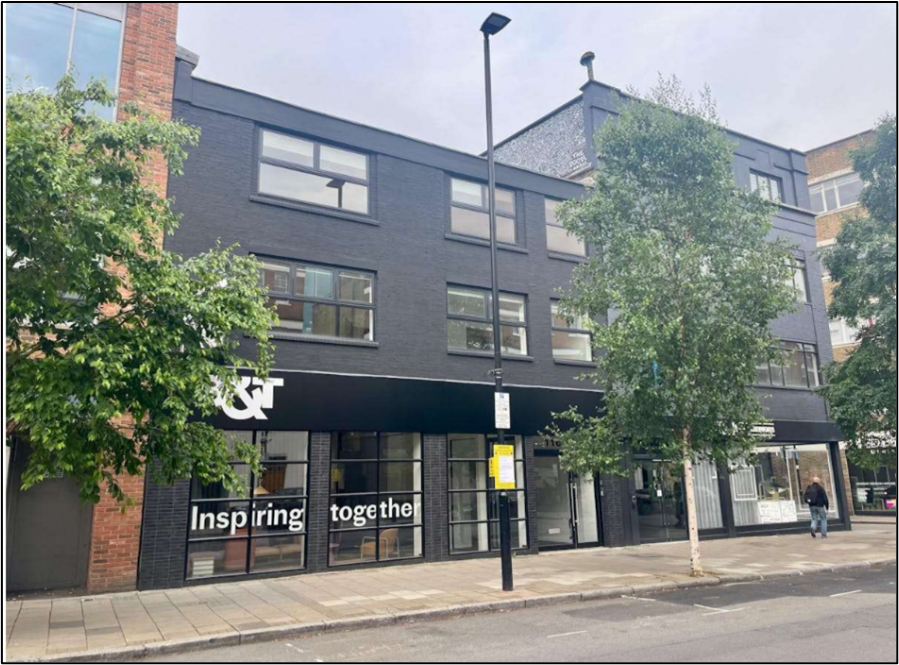 Street photo showing modern grey brick building with signage reading “Inspiring together,” located on Goswell Road, London.